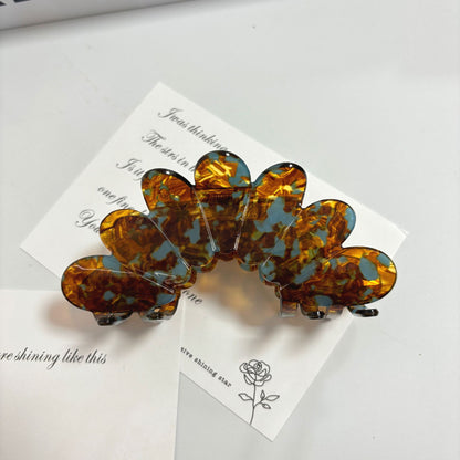 Petal Large Grip Hair Accessories featuring an elegant petal clip design in amber and blue.